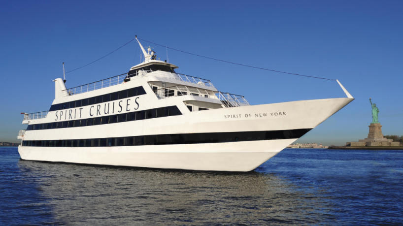 Spirit of New York yacht cruising near the Statue of Liberty.